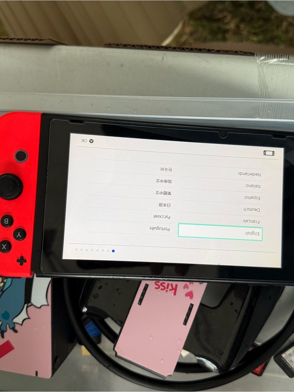Nintendo Switch with Red Left Joy‑Con and Black Screen Bezel